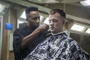 Master Sgt. Steven Covington, with 31st Marine Expeditionary Unit, cuts a Marine's hair aboard the USS Bonhomme Richard (LHD 6) at sea, March 8, 2016. The Marines and sailors of the 31st MEU are currently deployed aboard the Bonhomme Richard Amphibious Ready Group as part of their spring deployment to the Asia-Pacific region. (U.S. Marine Corps photo by Gunnery Sgt. Ismael Pena/Released)