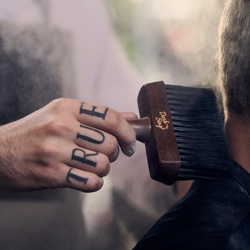 Dark Stag Neck Brush brushing a customers neck