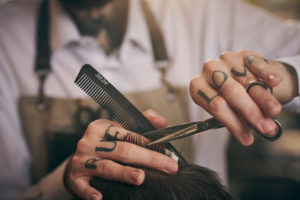 DS+ Straight Barber Scissor in barbers hand