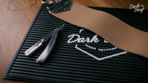 The Dark Stag Premium Razor on the Rubber Barber Station Mat, with the Buffalo Leather Strop